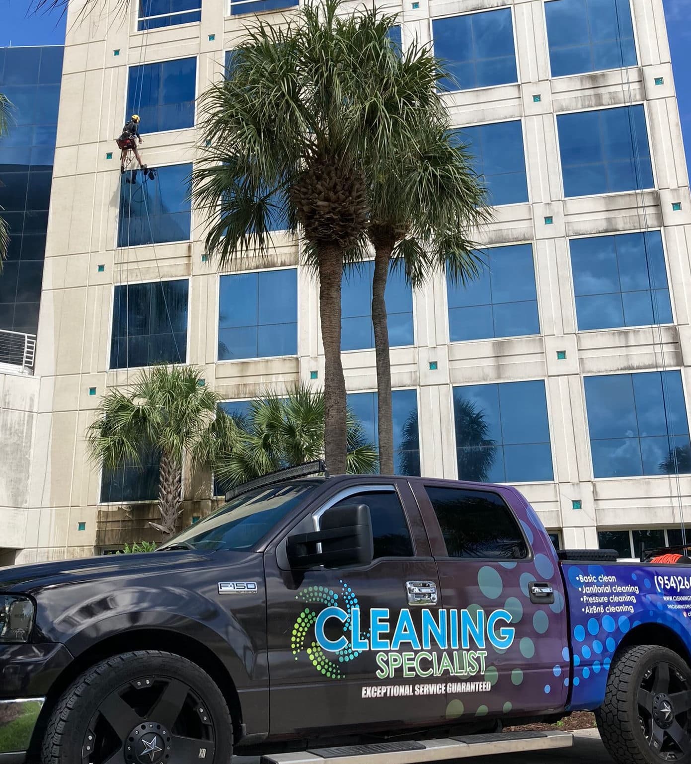 Cleaning Specialist USA truck and rope-access technician at a high-rise